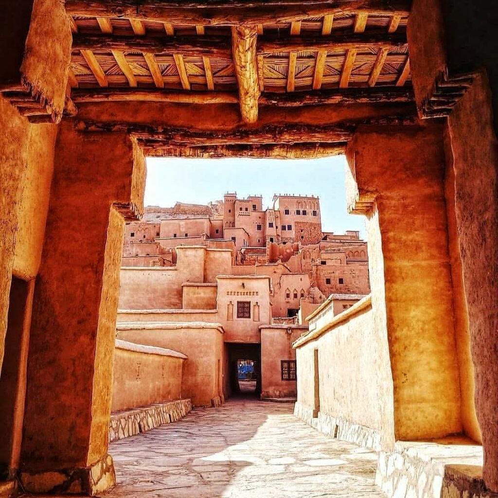 Earthen buildings at Ait Ben Haddou seen through a decorated doorway
